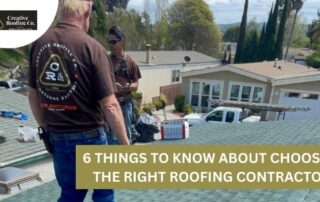 Roofers discussing roofing options on a residential roof with tools and materials nearby.
