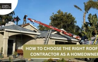 Roofers working on a house roof with a crane and construction materials nearby.