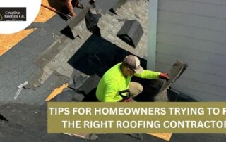 Roofers working on a residential roof with shingles and tools.