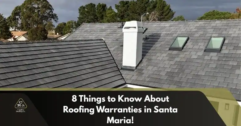 Roofers inspecting a gray shingle roof with dormers and skylights, showcasing craftsmanship and architectural detail.