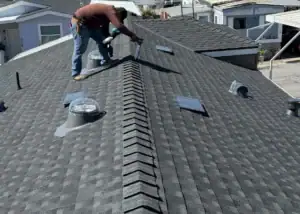 View of a new asphalt shingle roof with vents and skylights in South Higuera, California.