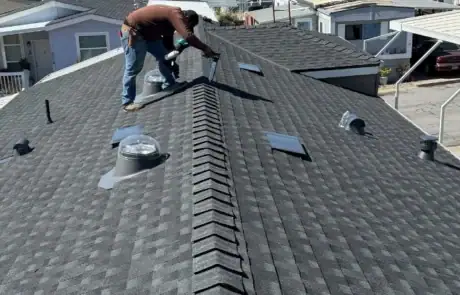 View of a new asphalt shingle roof with vents and skylights in South Higuera, California.